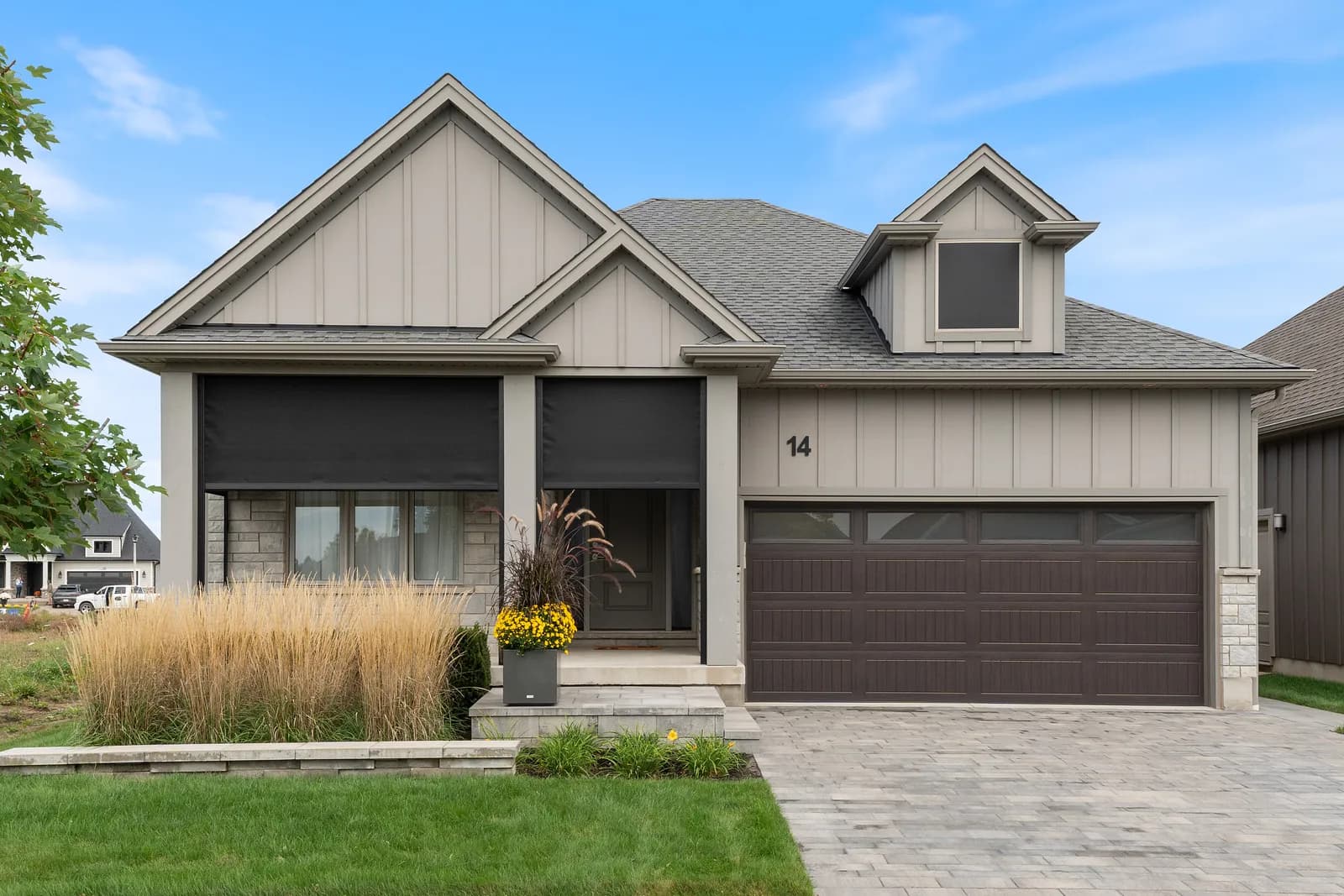 Suburban gable home with deployed dark mesh on covered porch