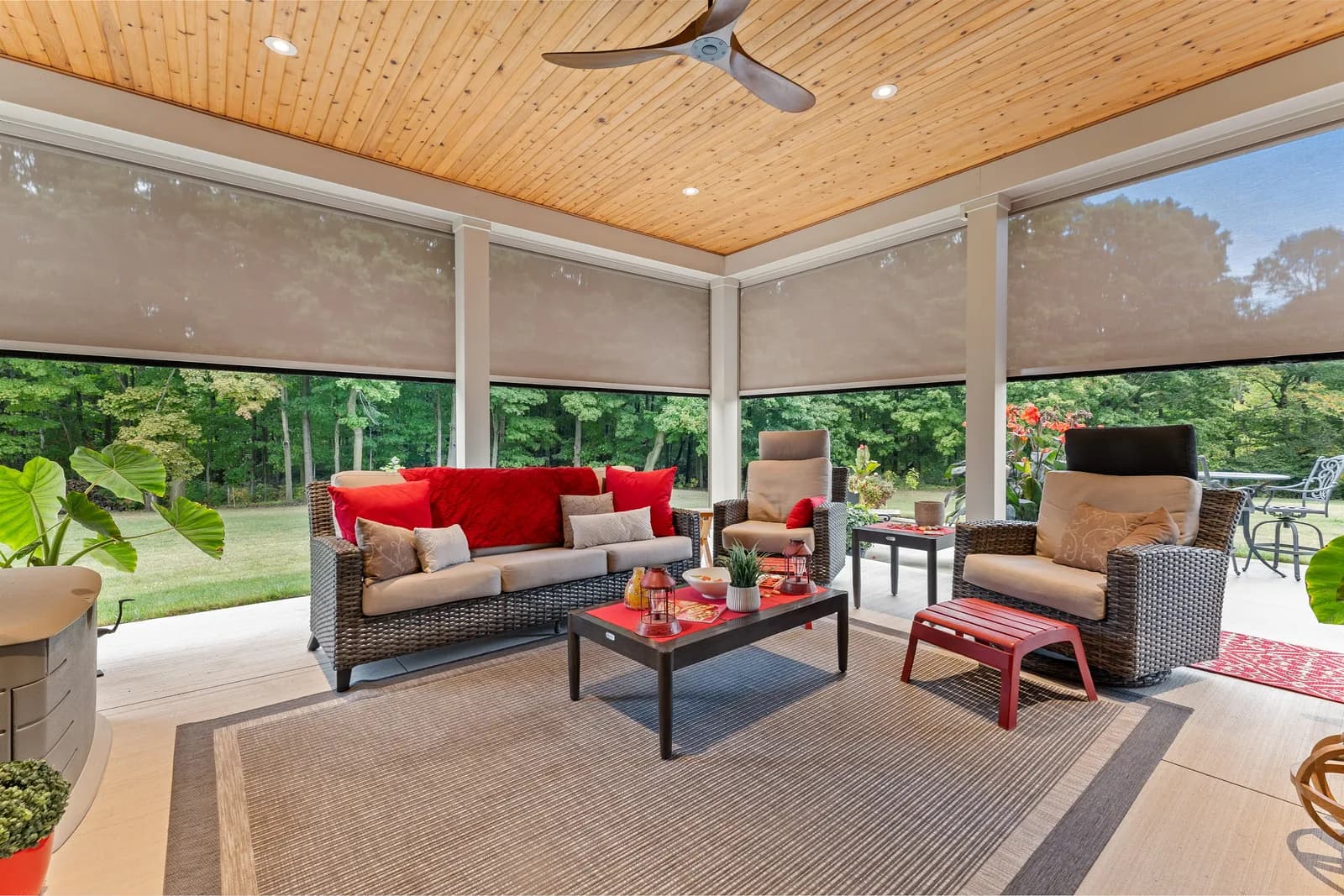 Interior view of covered porch with cream Habitat shades partially deployed